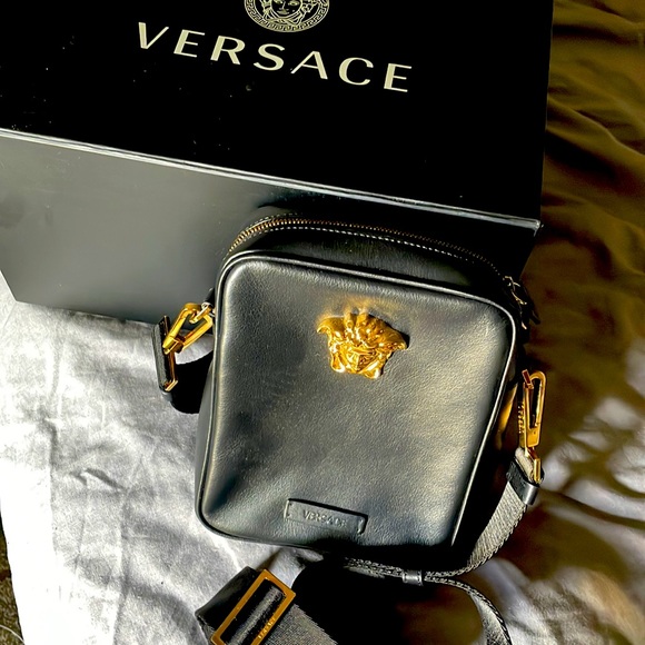 Versace mens authentic black/gold La Medusa cross body bag with zipper.